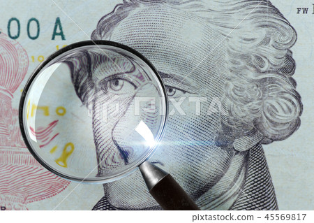 Dollar under a magnifying glass isolated Dollar under a magnifying glass isolated 45569817