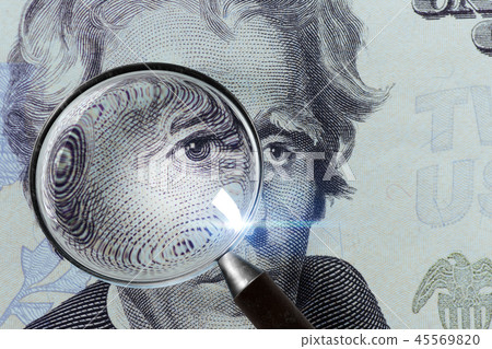 Dollar banknote under a magnifying glass is being inspected on white background Dollar banknote under a magnifying glass is being inspected on white background 45569820