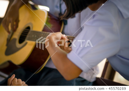 students are learning how to play guitar students are learning how to play guitar 45570289