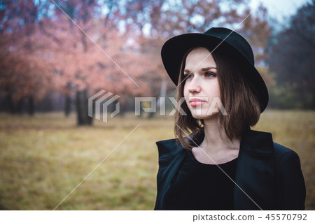 Portrait of a girl in a black hat Portrait of a girl in a black hat 45570792