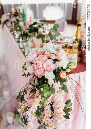 festive table for the bride and groom decorated with cloth and flowers festive table for the bride and groom decorated with cloth and flowers 45572408