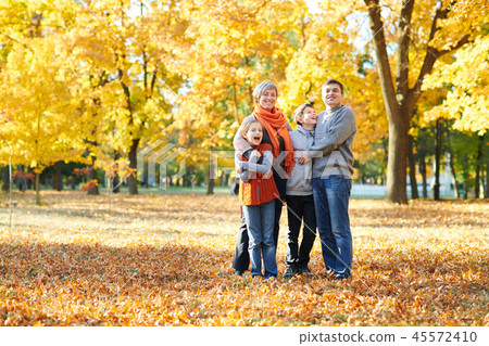 Happy family sit autumn city park on fallen leaves Happy family sit autumn city park on fallen leaves 45572410