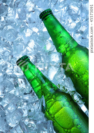 Bottle of beer in ice cubes.Closeup.Green bottle. 45573091