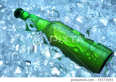 Bottle of beer in ice cubes.Closeup.Green bottle. Bottle of beer in ice cubes.Closeup.Green bottle. 45573093