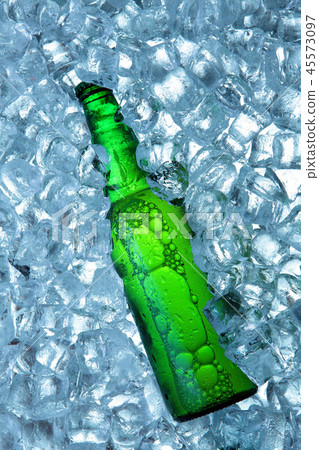 Bottle of beer in ice cubes.Closeup.Green bottle. Bottle of beer in ice cubes.Closeup.Green bottle. 45573097
