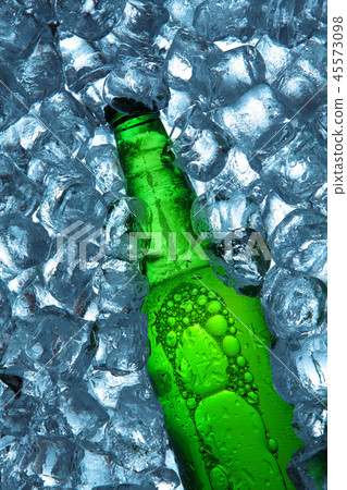 Bottle of beer in ice cubes.Closeup.Green bottle. 45573098