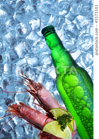 Bottle of beer with royal shrimp ice cubes.Closeup Bottle of beer with royal shrimp ice cubes.Closeup 45573101