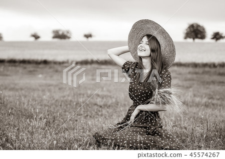 farm girl holding wheat ears on a field farm girl holding wheat ears on a field 45574267