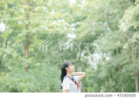 Portrait of asian japanese school girl costume looking at park outdoor film vintage style 45580089