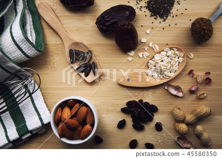 salt and nuts almond on wood background 45580350