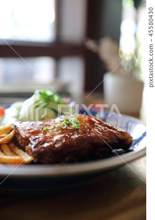 barbecued pork ribs steak with fresh vegetables on an old rustic wooden in restaurant barbecued pork ribs steak with fresh vegetables on an old rustic wooden in restaurant 45580430