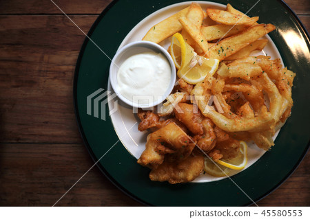 Fish and chips fried fish and potatoes on wood background vintage style 45580553