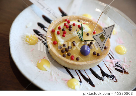 Lemon tart pie topping with chocolate ball sweet dessert on wood background 45580808