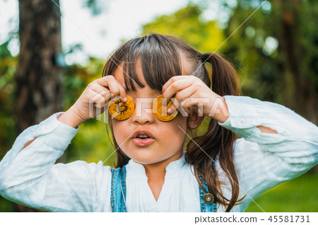 Little girl kid holding bitcoin digital money. Little girl kid holding bitcoin digital money. 45581731