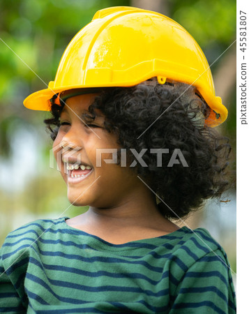 Happy little boy engineer wearing helmet hard hat. 45581807