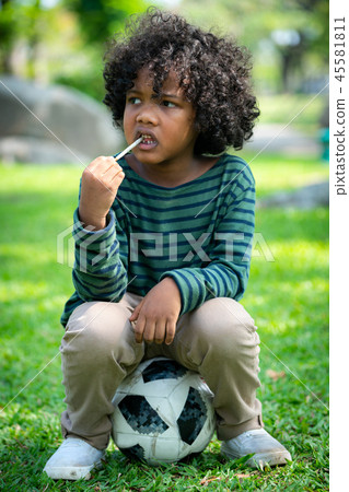 African american child eating snack stick. African american child eating snack stick. 45581811