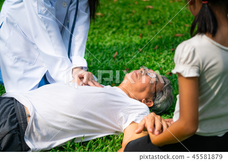 Doctor helping fainted senior man on the ground. Doctor helping fainted senior man on the ground. 45581879