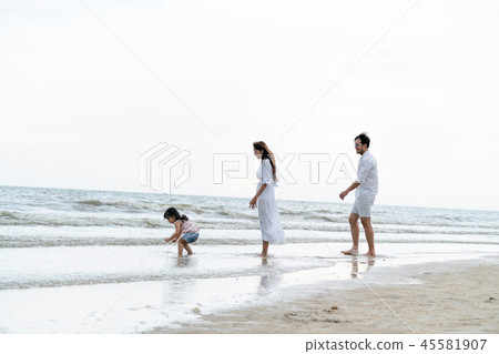 Happy family goes vacation on the beach in summer. 45581907