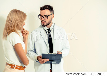 Male Doctor and Female Patient in Hospital Office 45582033