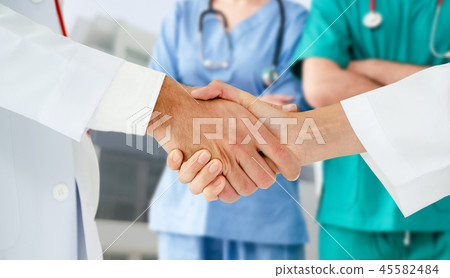 Doctor working in hospital with other doctors. 45582484