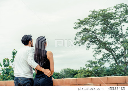 Happy couple take a romantic walk on the hills. 45582485