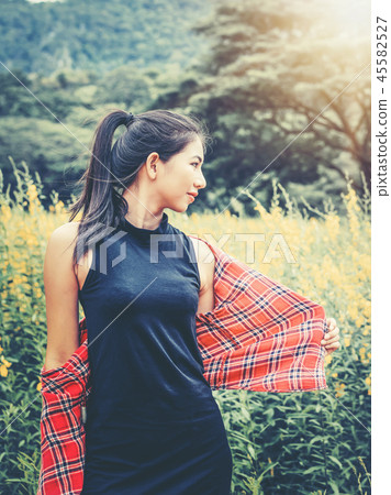 Happy woman in green field and mountain background Happy woman in green field and mountain background 45582527
