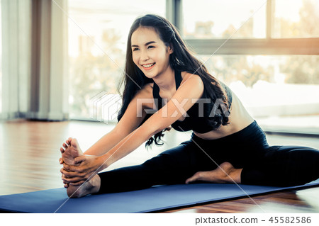 Young woman practice yoga in an gym studio. Young woman practice yoga in an gym studio. 45582586
