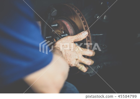 Disc brake and asbestos brake pads at car garage 45584799