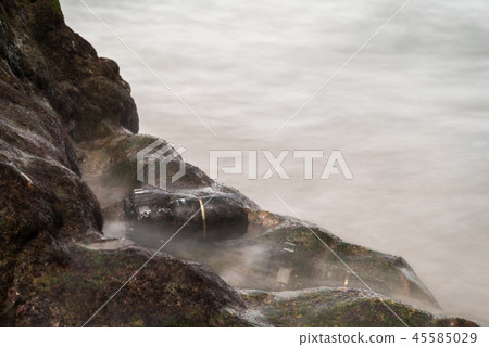 DSLR camera on beach wet from water sea wave DSLR camera on beach wet from water sea wave 45585029