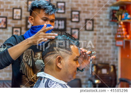 Barber haircut a customer at barbershop Barber haircut a customer at barbershop 45585296