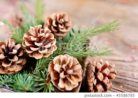 Christmas composition from branches of spruce and cones on a woo Christmas composition from branches of spruce and cones on a woo 45586785