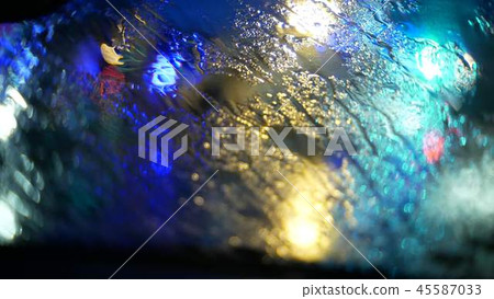 Car wipes remove rain at night in the city 45587033