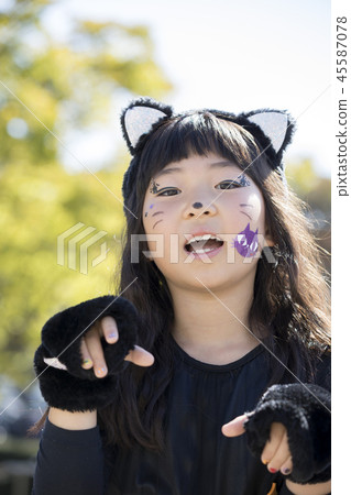 Halloween image Primary school girl dressed in black cat 45587078