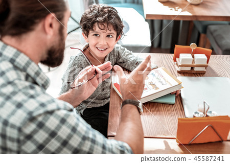 Private tutor wearing hand watch teaching little cute preschooler 45587241