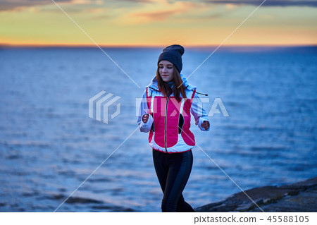 A young girl in a sports hat and jacket makes A young girl in a sports hat and jacket makes 45588105