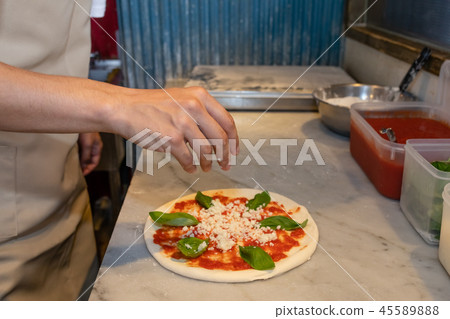 Pizzeria cooking pizza Pizzeria cooking pizza 45589888