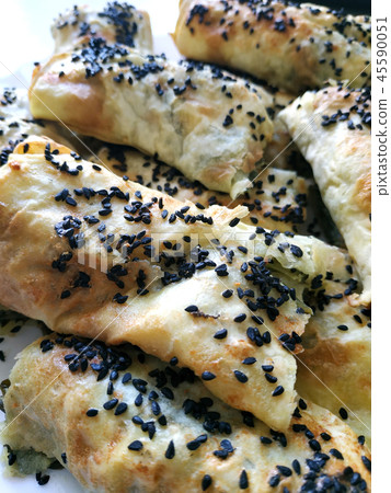 Cutted lavash pieces with vegetables. Burek with spinach and cheese and black cumin. Yufka Cutted lavash pieces with vegetables. Burek with spinach and cheese and black cumin. Yufka 45590051