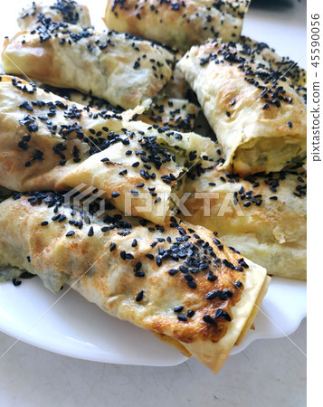 Cutted lavash pieces with vegetables. Burek with spinach and cheese and black cumin. Yufka 45590056