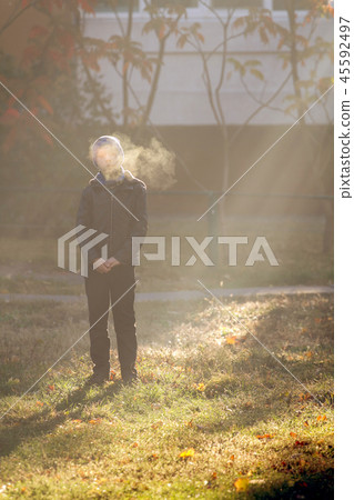 Boy on frosty morning in park Boy on frosty morning in park 45592497