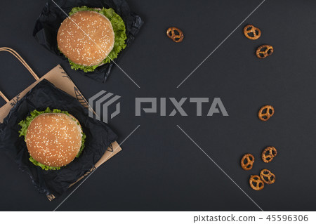 Two hamburger on a black background for lunch. Fast food and snacks. Free space for text. Copy space 45596306