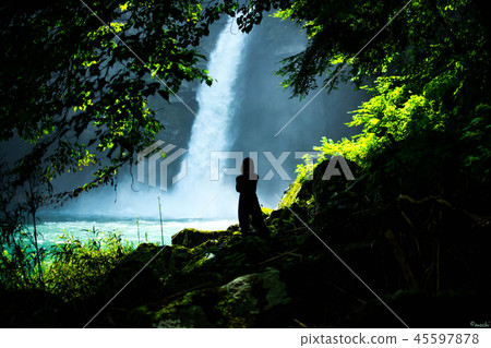 Waterfall and woman silhouette Waterfall and woman silhouette 45597878