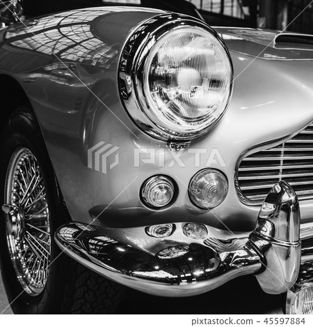 closeup of the headlights and front bumper on vintage automobile closeup of the headlights and front bumper on vintage automobile 45597884