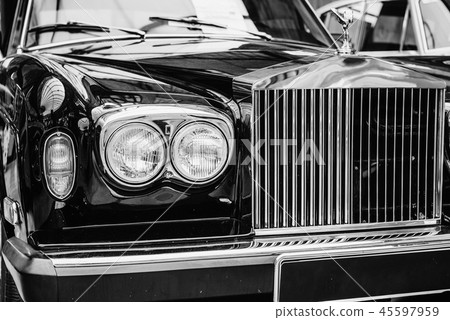 closeup of the headlights and front bumper on vintage automobile closeup of the headlights and front bumper on vintage automobile 45597959