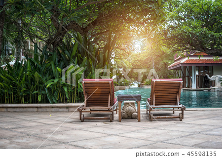 Beautiful sunbed chair near the swimming pool Beautiful sunbed chair near the swimming pool 45598135