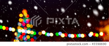 Christmas tree in the snowfall by night 45598690