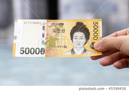 Man hold south korea banknote 50000 won Man hold south korea banknote 50000 won 45599438