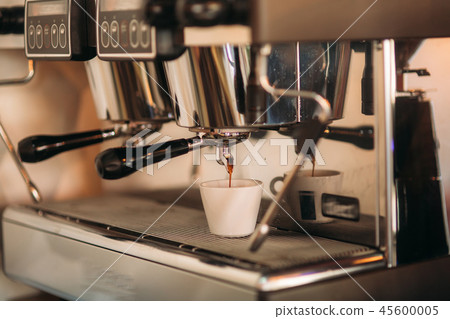 Barista using a coffee machine in cafe Barista using a coffee machine in cafe 45600005