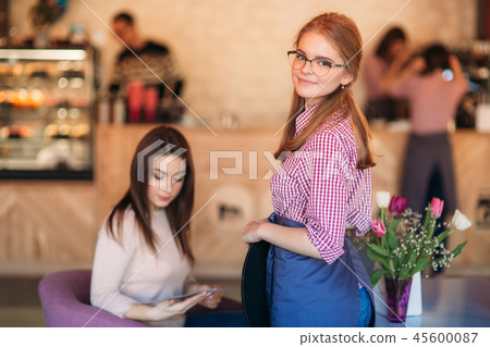 Mid section of waitress taking order at restaurant Mid section of waitress taking order at restaurant 45600087