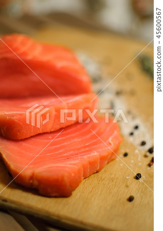 Sliced salmon fillet and pepper on cutting board Sliced salmon fillet and pepper on cutting board 45600567