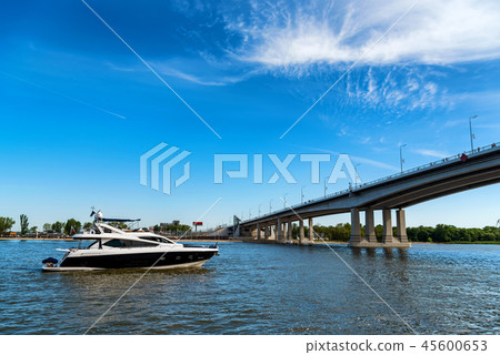 High speed boat on river and bridge on sunny day High speed boat on river and bridge on sunny day 45600653